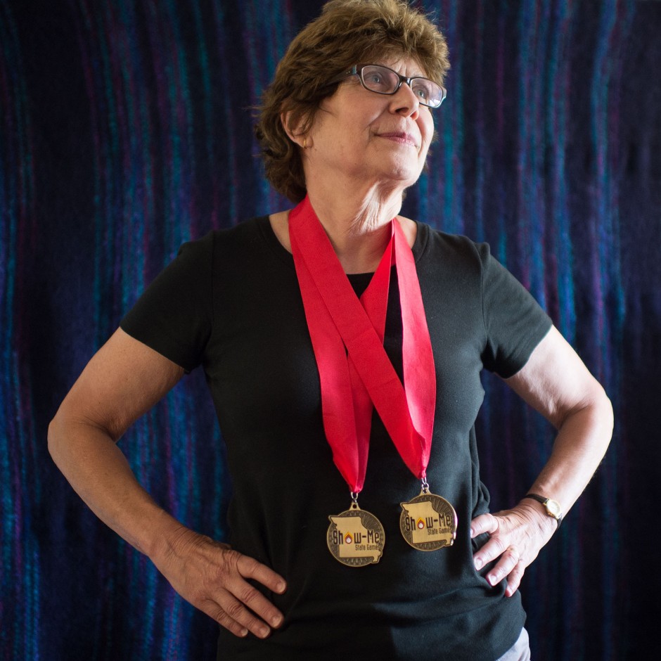 Louise Miller stands with two medals around her neck.