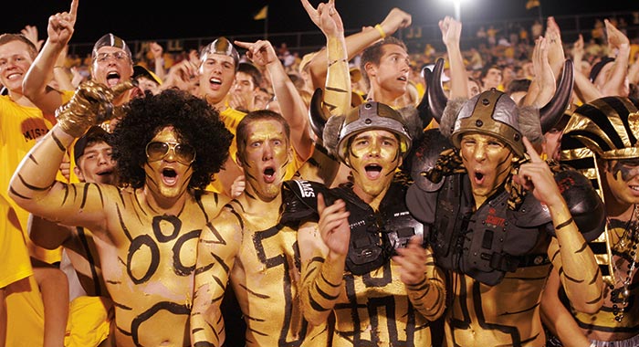 Guys in gold paint and costumes at a Mizzou football game