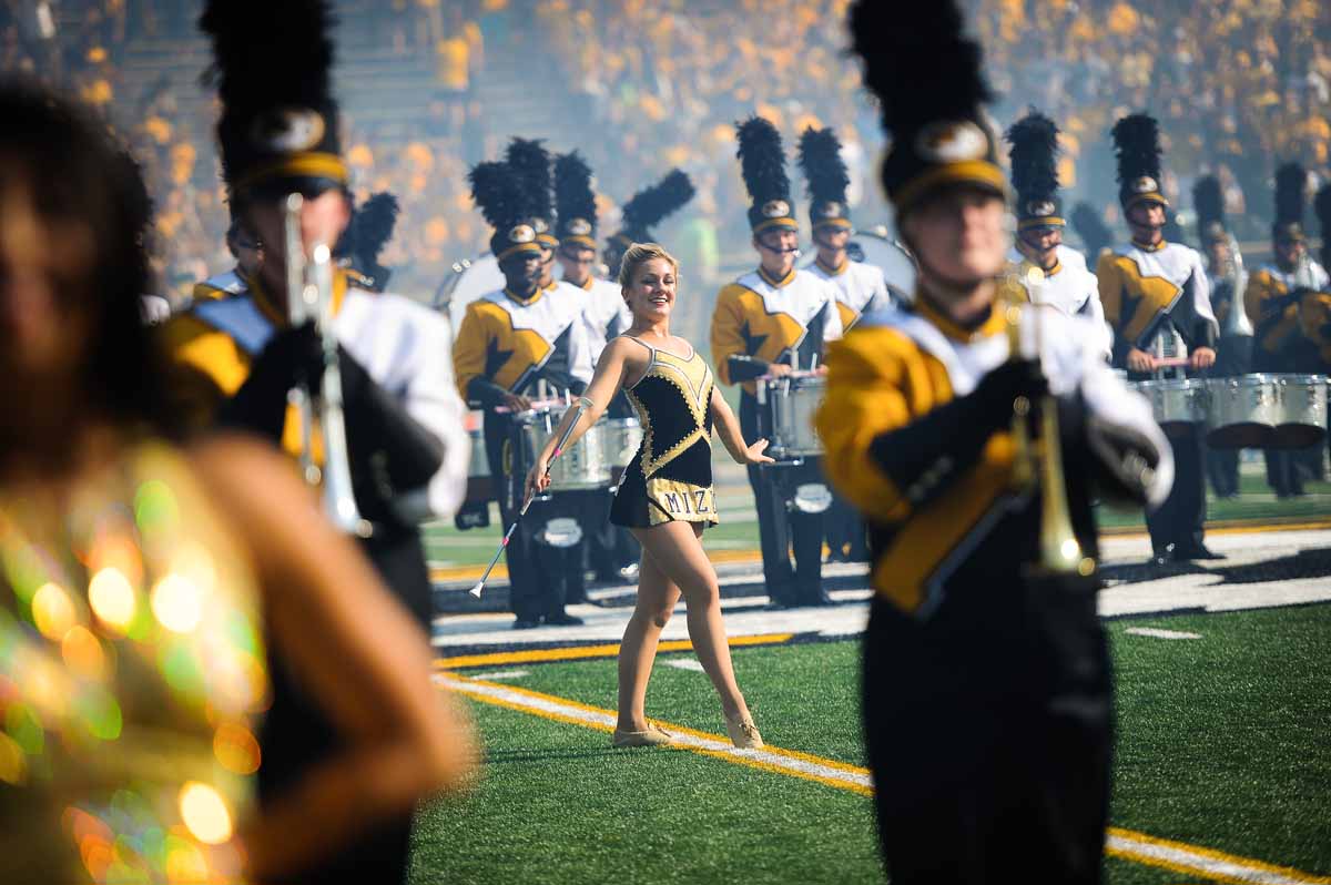 A featured twirler performs during pre-game festivities.