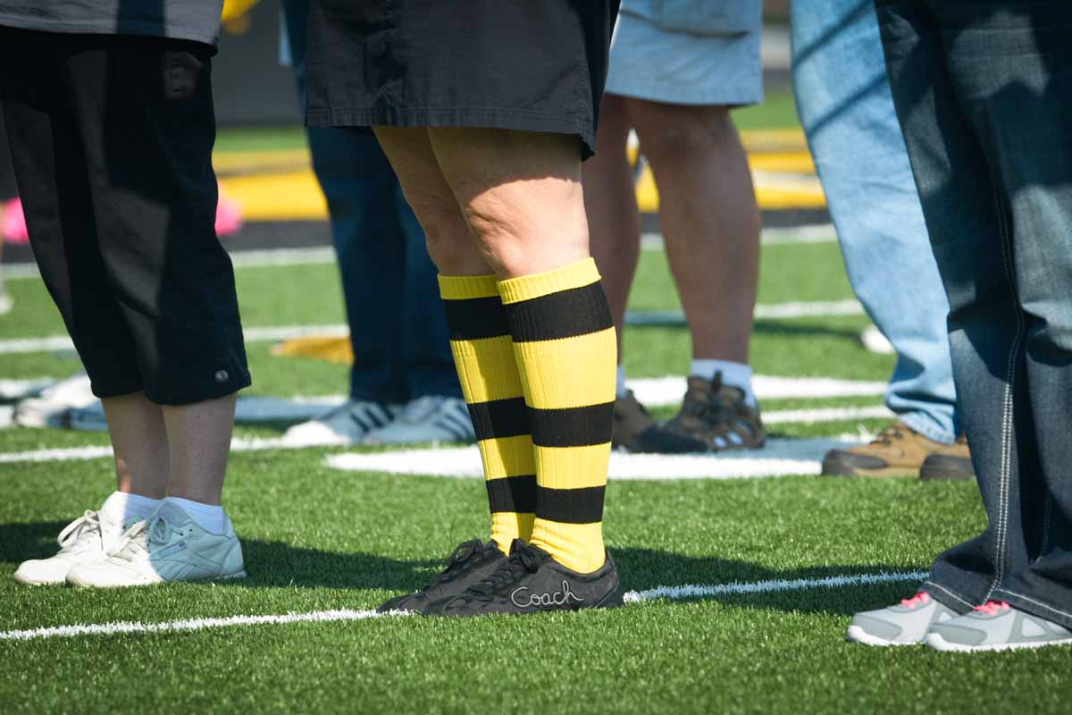 A member of the alumni band sports black and gold socks.