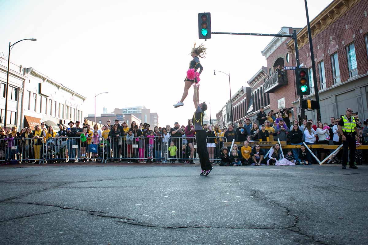 The MU cheerleaders perform downtown at the Homecoming Parade.