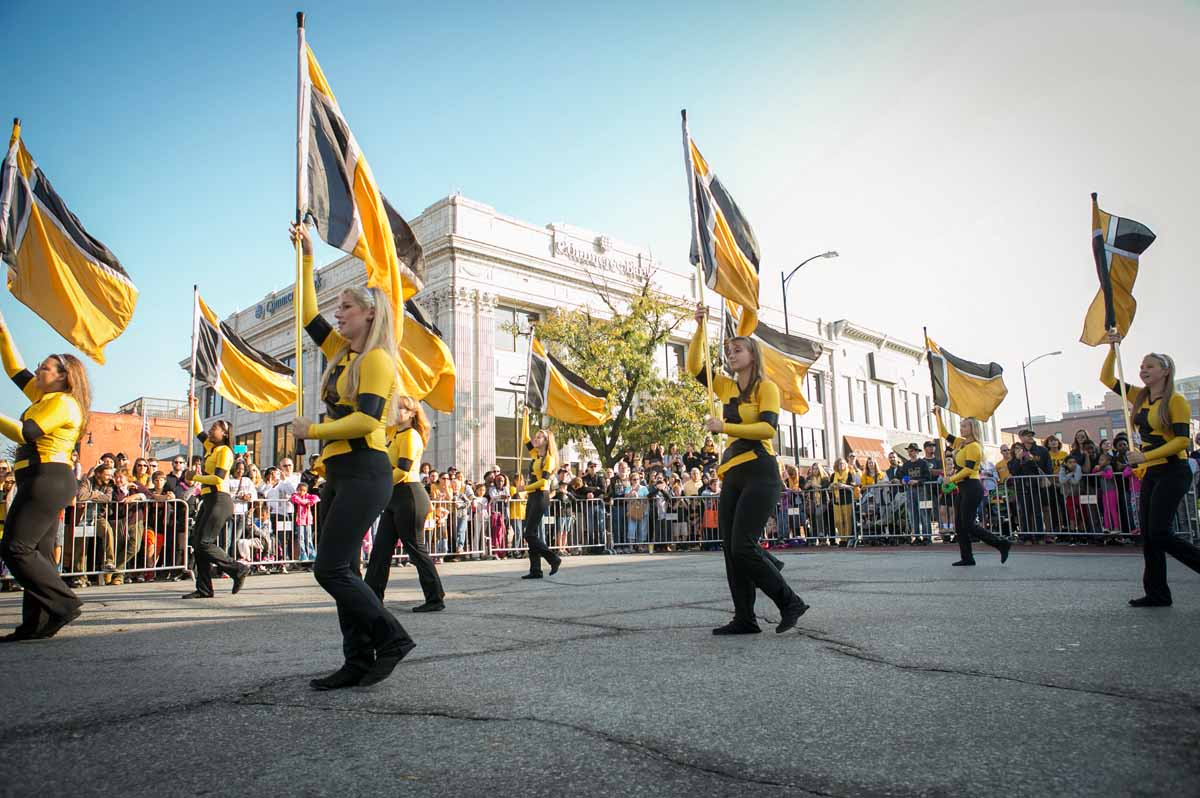 The MU color guard performs downtown at the Homecoming Parade.