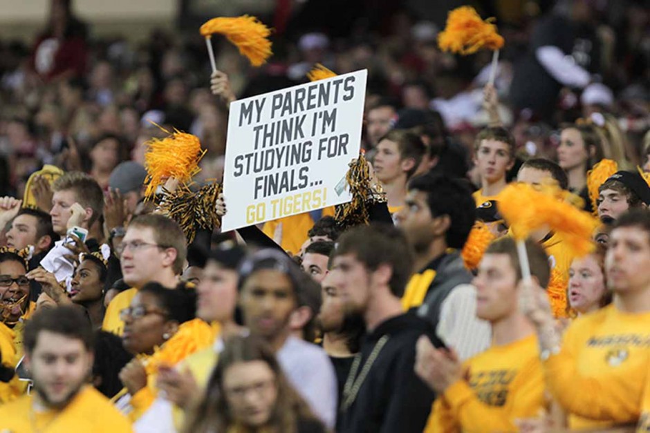 Crowd of Mizzou fans holding signs.