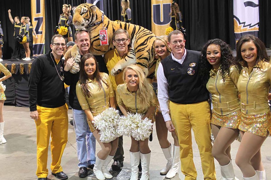 Tim May, Paul Shomper, Philip Schroeder and Ron Henry with dancers and stuffed tiger.