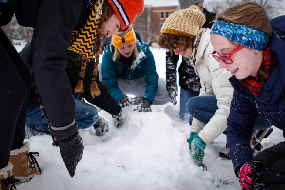 Morgan Magid, Jared Kaufman, Brooke Auer, Taylor Ysteboe, Erin Bormett and Anna Maples (left to right) help each other build a fort on the quad. The freshmen spent their snowday taking part in the snowball fight at noon. Photo by Tanzi Propst.