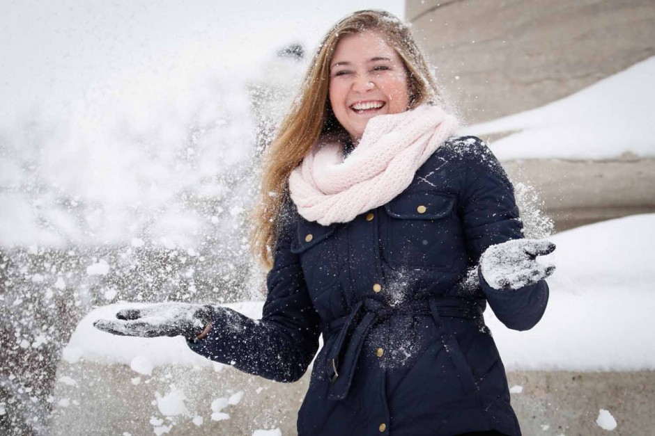 Sophomore Amanda Walters throws snow into the air, overjoyed that Mizzou called a snowday. Photo by Hanna Yowell. 
