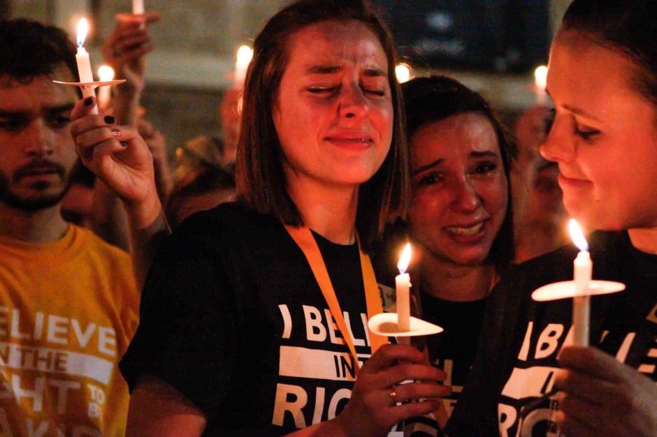 Shelby McGee and Amanda Gingrich holding candles.