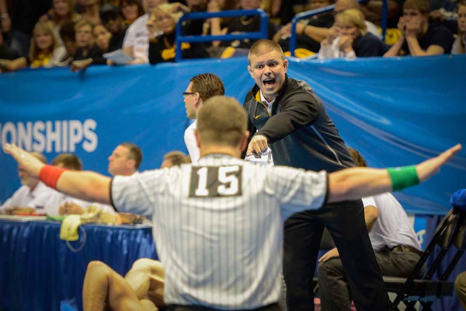 Head assistant coach Alex Clemsen points out a move in Drake Houdashelt's match against Purdue's Brandon Nelson.