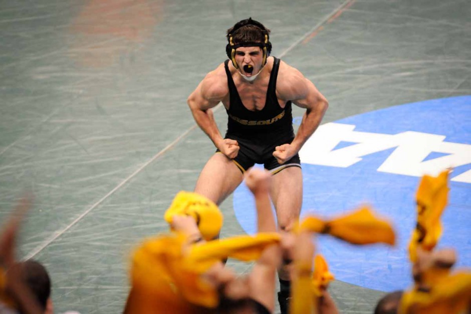 Willie Miklus celebrates a win by pin against Wisconsin's Richard Roberston in the 184-pound division.
