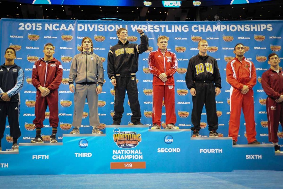 Drake Houdashelt faces the Mizzou section of the crowd at the Scottrade Center and pumps his fist while standing in the top spot on the 149 pound podium.