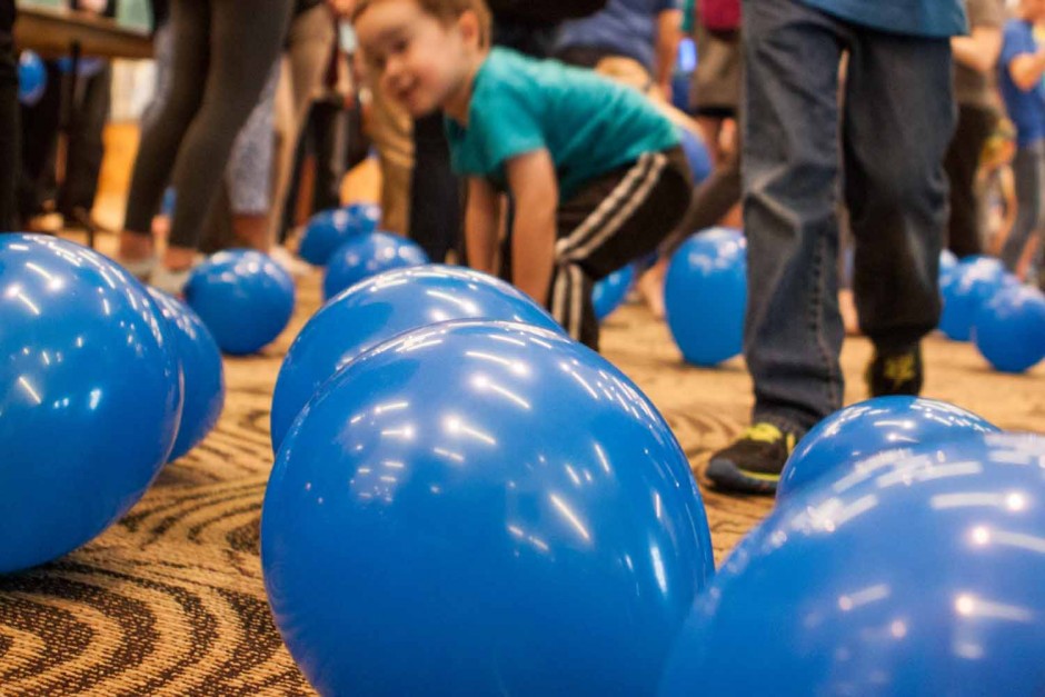 Parents and kids were allowed to play with and keep the balloons that had been released after the ribbon cutting at Light It Up Blue, Thursday, April 2, 2015.