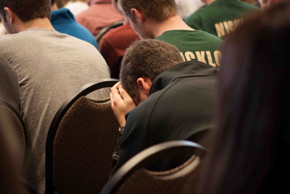 Jack Zimmerman, 18, rests his head in his hands. He attended the ceremony in honor of Jack Lipp.