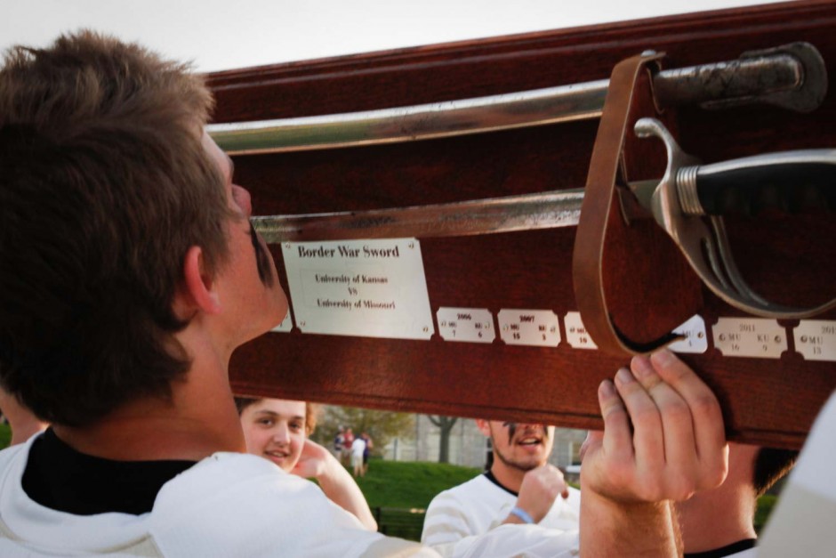 Members of the team passed the Civil War sword between players, taking turns to kiss the blade in honor of their win over Kansas.