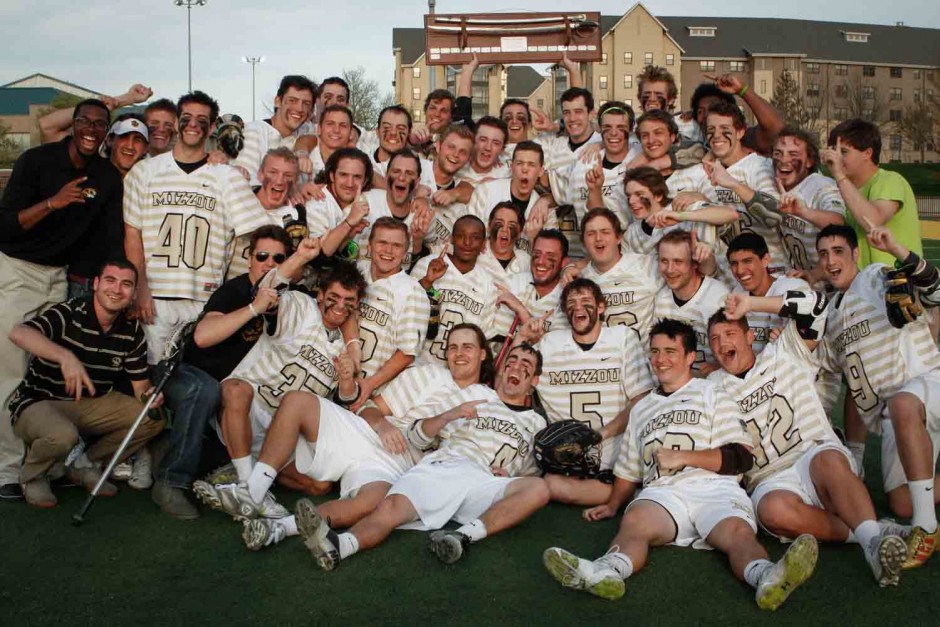 Members of the lacrosse team pose for a portrait after the game.