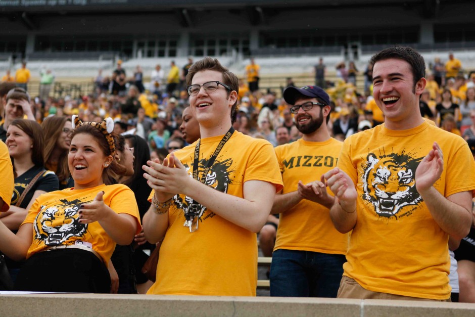 (From left to right): Taryn Herbst, freshman, Chris Green, sophomore, and Ryan Layton, freshman, cheer during the first play of the spring game. The students sat in the Tiger's Lair section of Memorial Stadium and stayed through the end of the game.