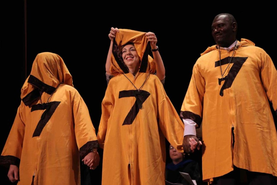 Three people in yellow robes.