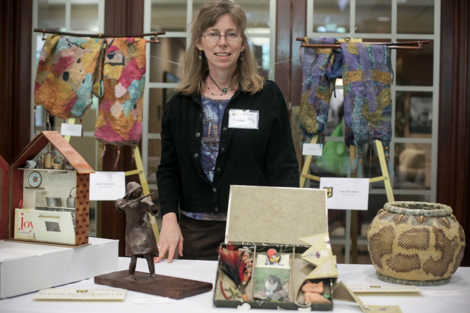 Fiber Artist Amy Shomaker from the MU School of Journalism stands infront of her exhibition table at the 2015 MU Arts and Crafts Showcase.