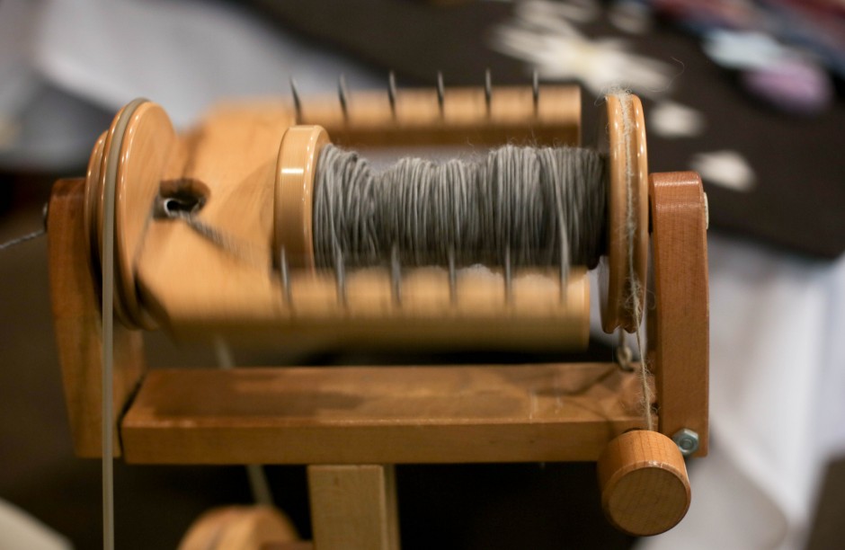 Linda Coats, from MU Career Planning and Placement spins Alpaca fiber into yarn. Coats said it takes approximately one hour to fill a single spool. After she has filled two spools, she then turns the wheel the other way and spins them together to create two-ply yarn, which is much stronger.