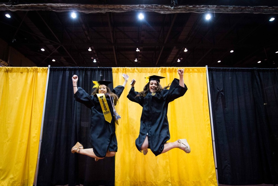 Caroline Bequette and Michelle Sterkowicz, both hospitality management majors, jump for joy.