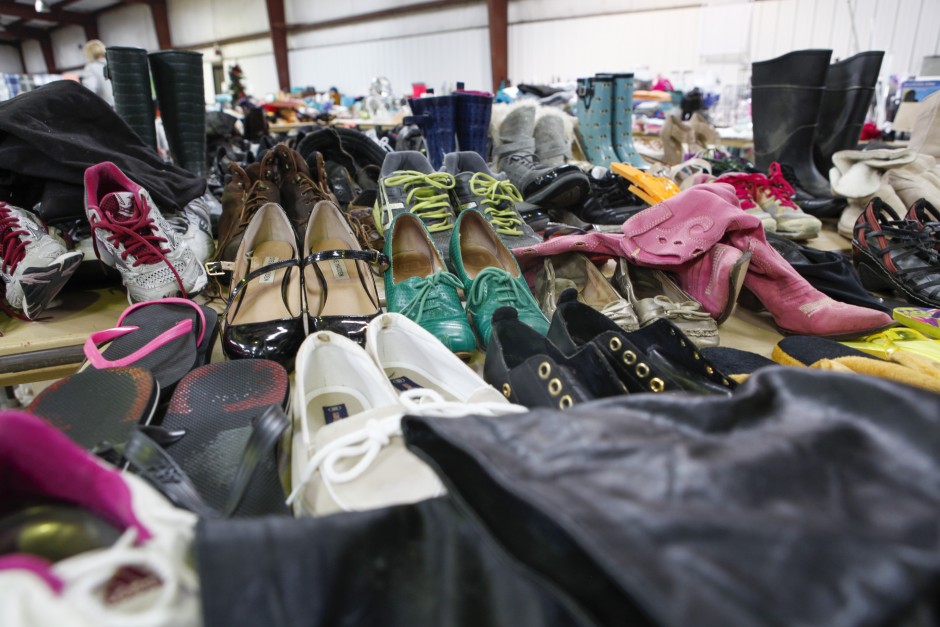 A seemingly endless supply of shoes sit on multiple tables inside the Mizzou surplus property warehouse, Wednesday, May 20, 2015. The variety ranges from sandals, to rain boots, to tennis shoes, to high heels and more.