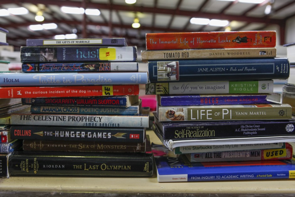 Stacks of books, both for academic and leisure, line a table near the office supplies, ready to be sold during the Tiger Treasures Rummage Sale on Saturday, May 30, 2015. Books ranging from used textbooks to more modern reads like "The Hunger Games" can be found.