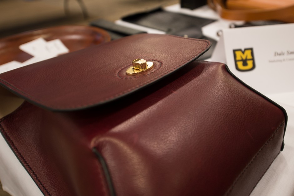 Mizzou Creative employee Dale Smith fills his table with handmade leather goods.