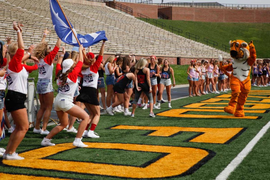 Truman the Tiger runs in front of sorority chapters gathered on the West side of Faurot Field Sunday morning. Many of the seniors pulled Truman aside for group photos and selfies.