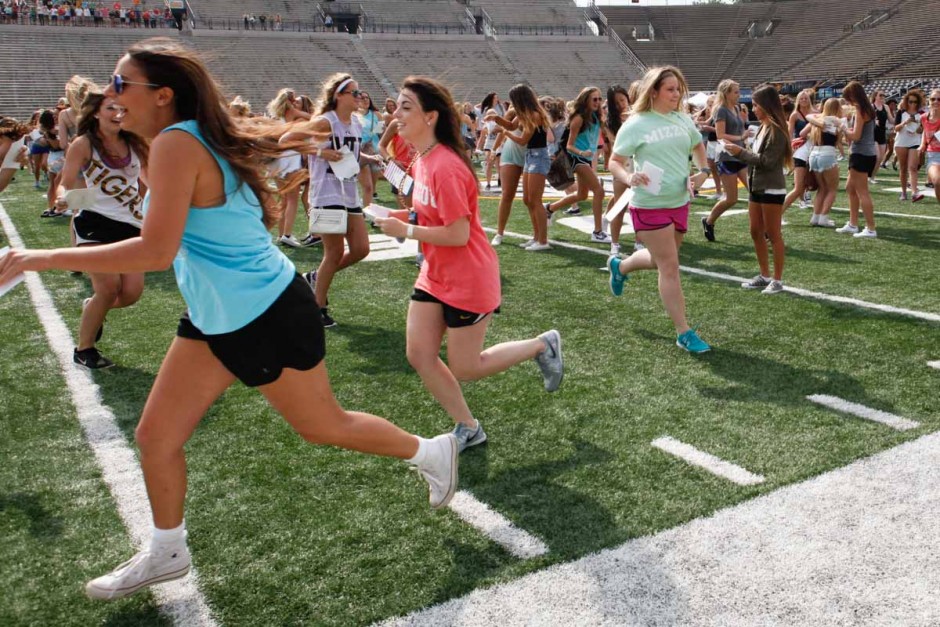 Girls running on the football field.