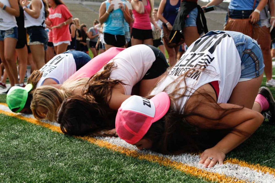 Members of Zeta Tau Alpha kiss the 50-yard-line before continuing on to exit Faurot Field and walk back to Greek town Sunday morning. The 50 was a popular spot this morning, as everyone had to get their chance to partake in the Mizzou tradition.