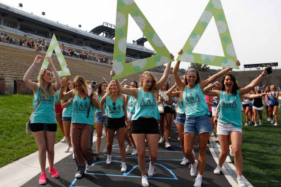Delta Delta Delta starts their walk back to Greek town after being released from Faurot Field Sunday morning. All chapters had large, wooden letters decorated with their houses colors that members were able to pose with for photos.