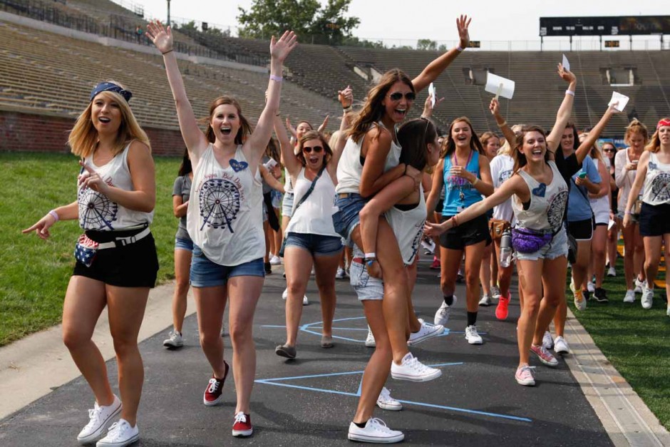 Members of Sigma Kappa jump and scream with excitement as they gather up their new members and head to exit Faurot Field Sunday morning. Bid Day's first year on Faurot proved to be more organized than previous years on the Quad.