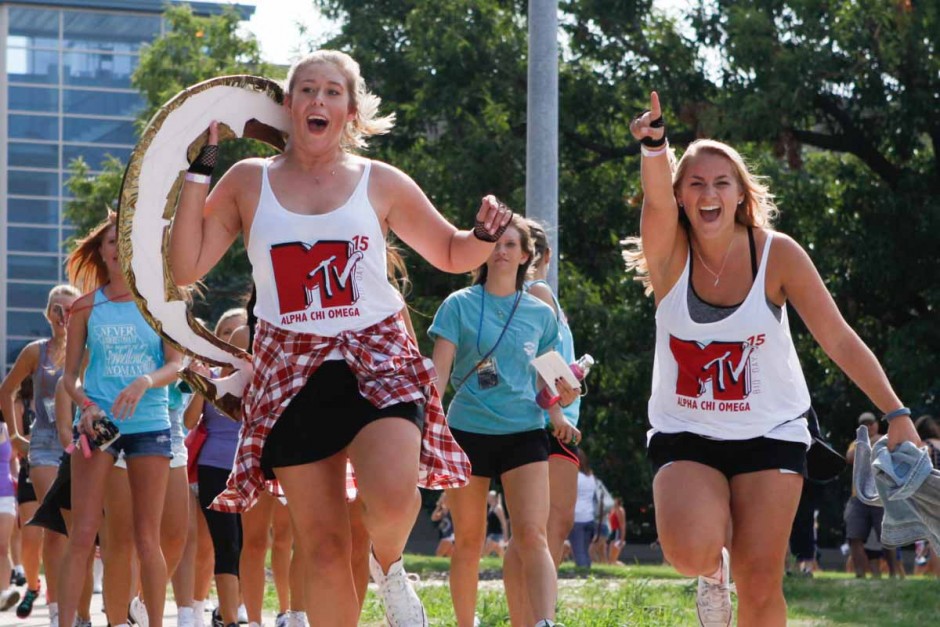 Alpha Chi Omega seniors lead their group of new recruits back to Greek town after the Bid Day reveal on Faurot Field Sunday morning.