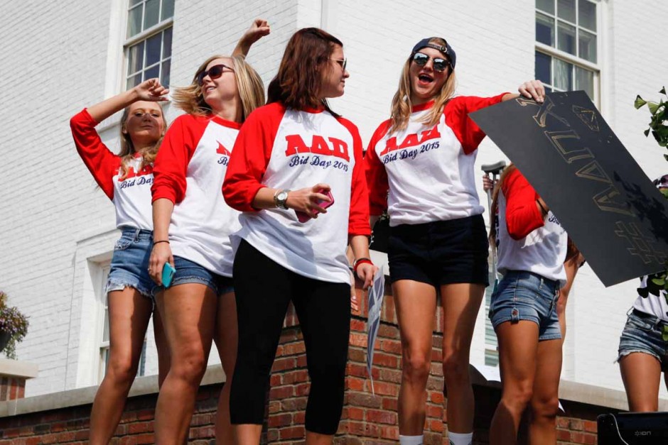 Members of Alpha Delta Pi dance on the southeast edge of their house as younger members welcome new freshman into their house.