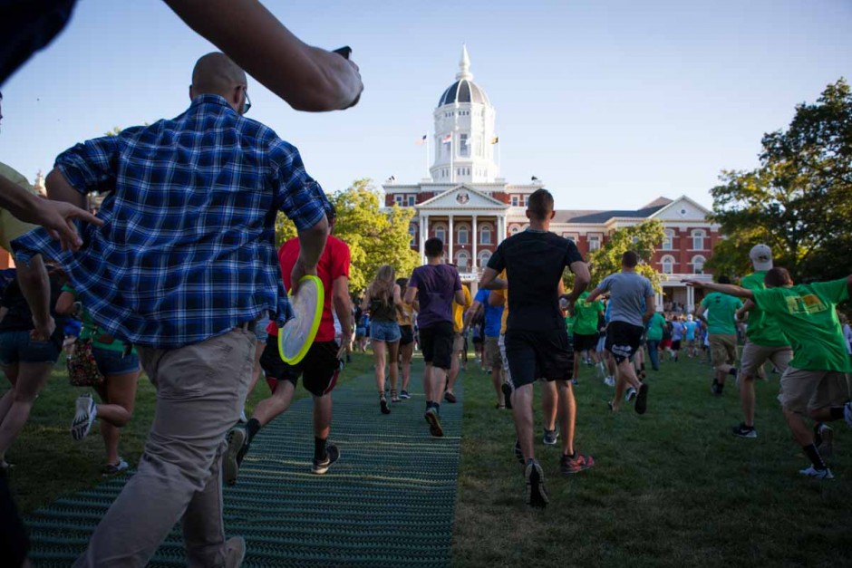 After students passed through the columns on the Quad, it became a race to Jesse Hall in a fit of excitement. Many of the freshmen stopped to high-five Chancellor Loftin and stop for a selfie. Photo by Tanzi Propst.