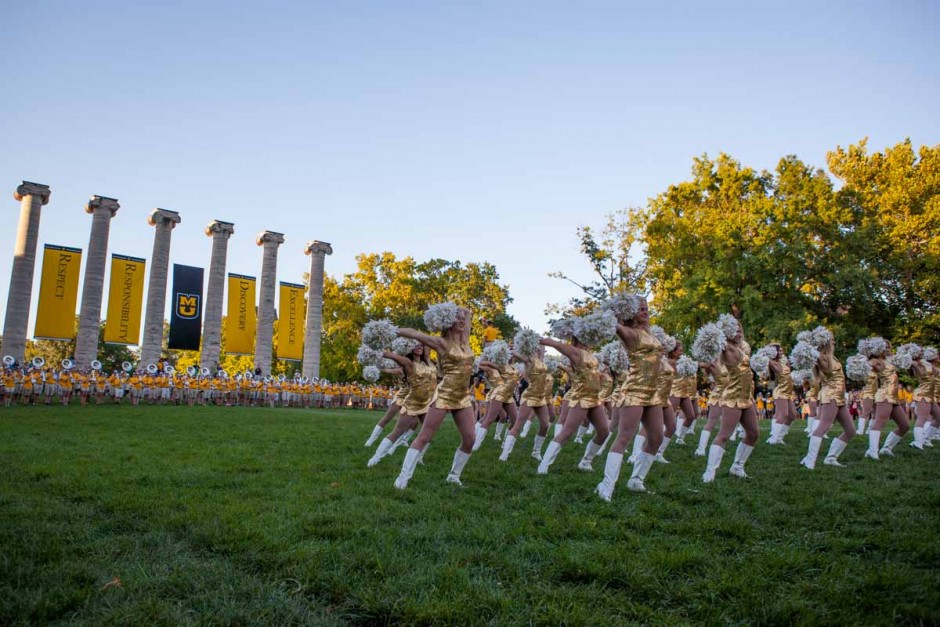 The Mizzou Golden Girls perform in front of Jesse Hall to a crowd of freshmen, parents and other Mizzou students as Marching Mizzou plays fan favorites in the background Sunday evening. This year marks the 50th anniversary of the Golden Girls at Mizzou. Photo by Tanzi Propst.