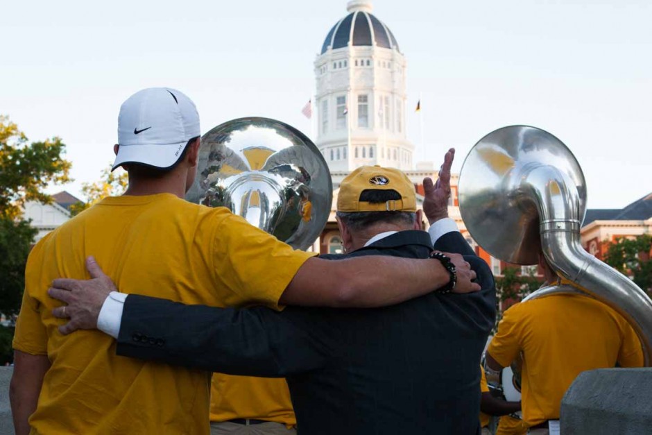  Chancellor Loftin sways with a student to Marching Mizzou's final song, Mizzou's Alma Mater. Photo by Tanzi Propst.