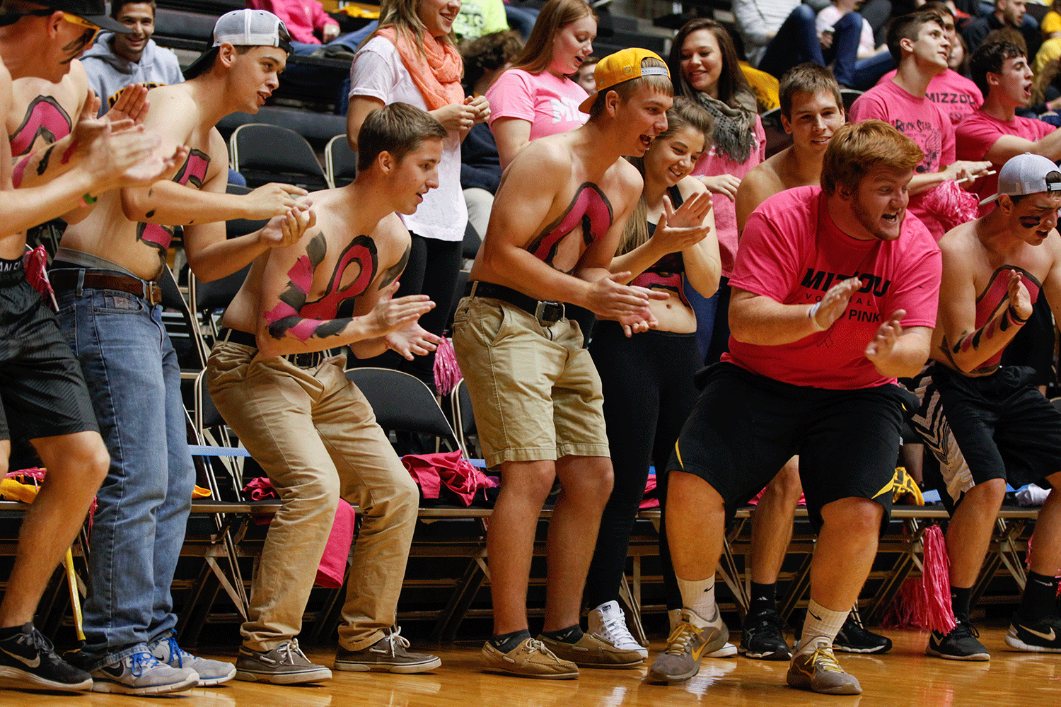 Members of the VolleyZou crew cheer on the Tigers as they serve to Ole Miss during the first set.