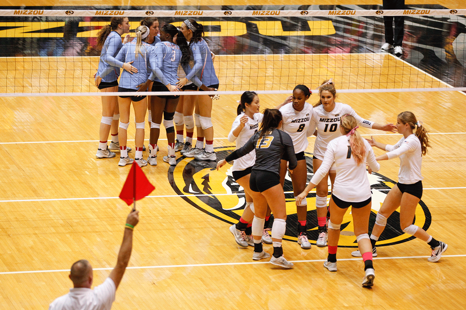 The Tigers bring it in, giving each other high-fives and words of encouragement after earning another point against Ole Miss during the second set.