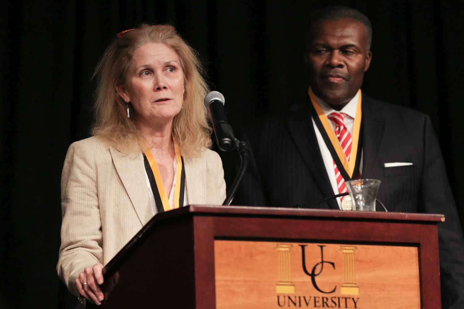 Sandy Rosenbush, an ESPN event news editor, accepts an honor medal on behalf of the Sports Journalism Institute, along with Leon Carter. The two are co-directors of the Institute, a nine-week training and internship program for college students interested in sports journalism careers. The Institute is designed to attract talented minorities and women to journalism through opportunities in sports reporting and editing as well as enhance racial and gender diversity in sports departments nationwide.