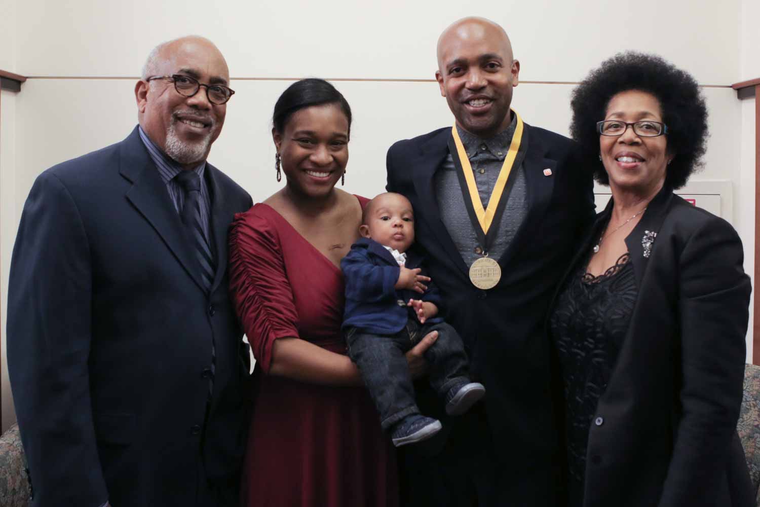 Lincoln Stephens poses for a portrait with his wife, parents and baby.