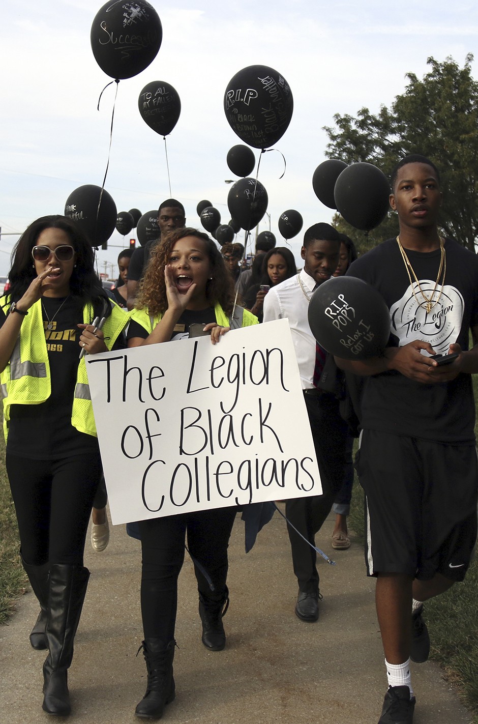 Legion of Black Collegians marching down the street.