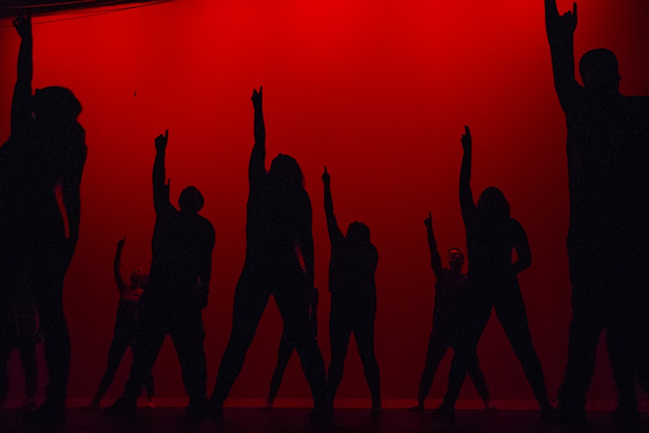  Silhouetted dancers pointing upward