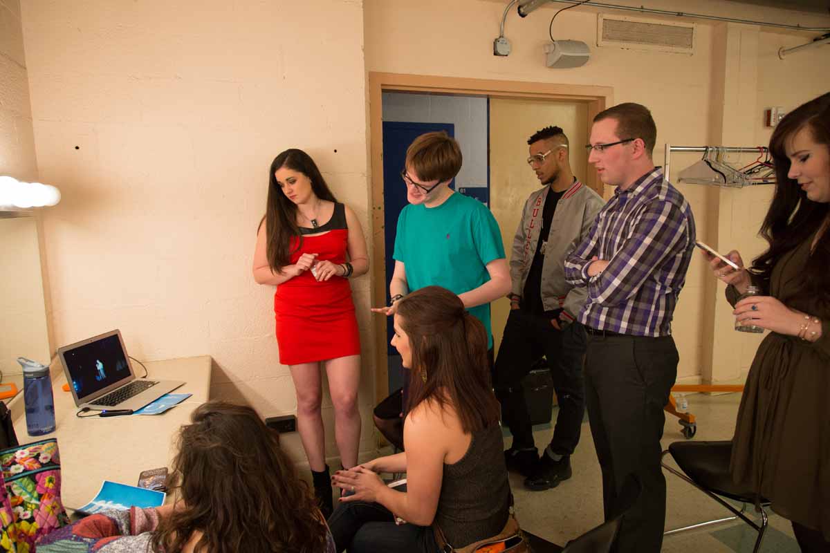 Contestants gather around a computer in the dressing room to watch the MU Film Crew livestream of Mizzou Idol 2016. Photo by Jake Hamilton.