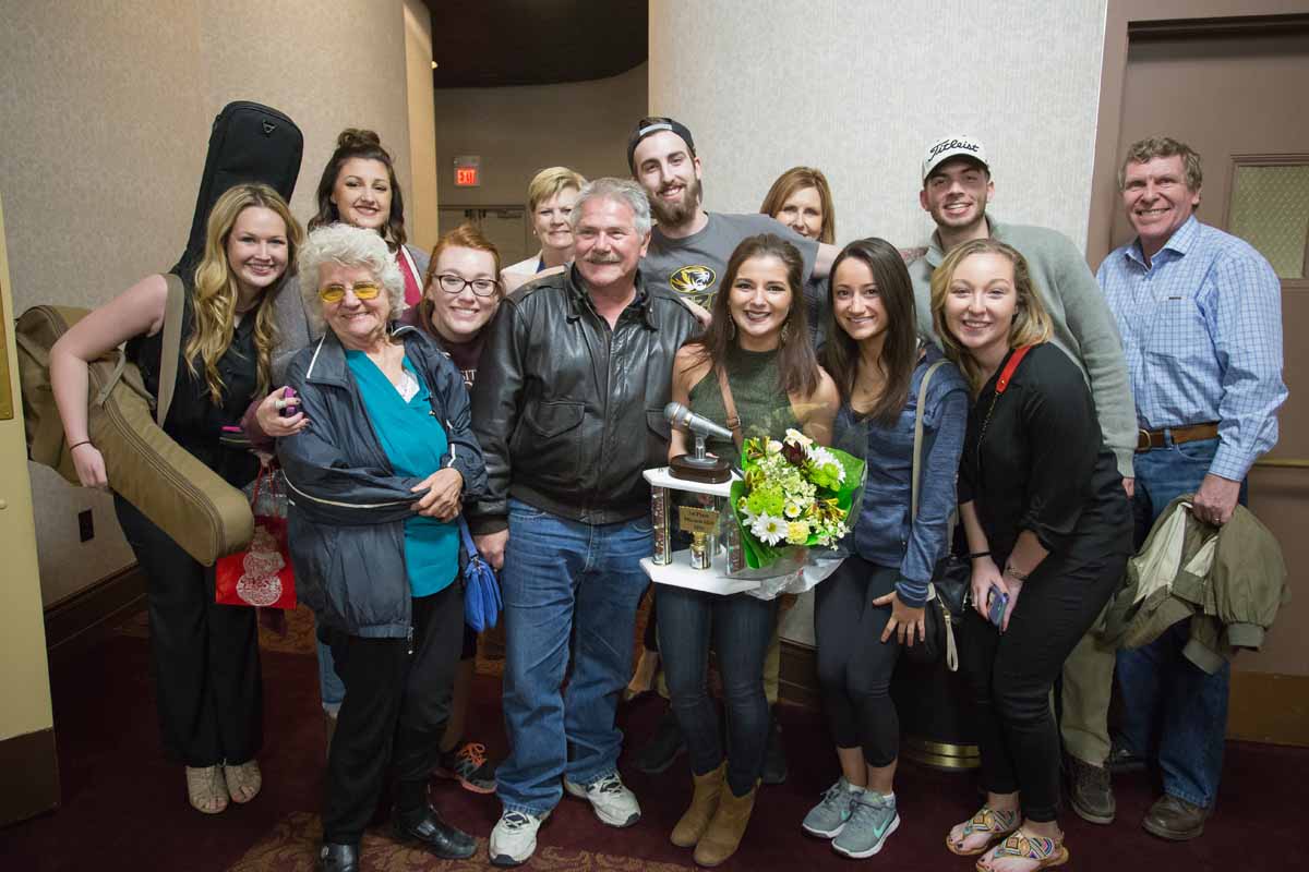 Mizzou Idol Winner Breanna Lehane poses with friends and family along with her first place trophy after the show. Photo by Jake Hamilton.