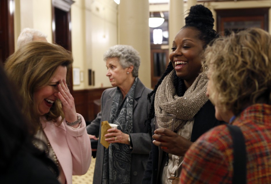 From left, Zora Mulligan and Tamar Hodges laugh with Kelley Stuck during the reception in the foyer of Jesse Hall just before the "Contesting Slavery: Enslaved MissouriansÕ Enduring Struggle for Self Determination" presentation Wednesday evening, Feb. 3, 2016.