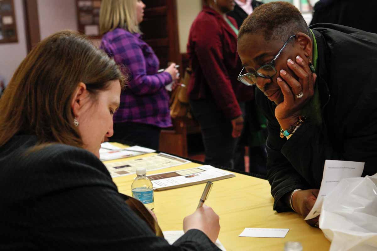 Traci Wilson-Kleekamp watches intently as her friend, Professor Diane Mutti Burke, signs a copy of "Contesting Slavery: Enslaved Missourians’ Enduring Struggle for Self Determination" for her Wednesday evening, Feb. 3, 2016 in the foyer of Jesse Hall. Photo by Tanzi Propst.