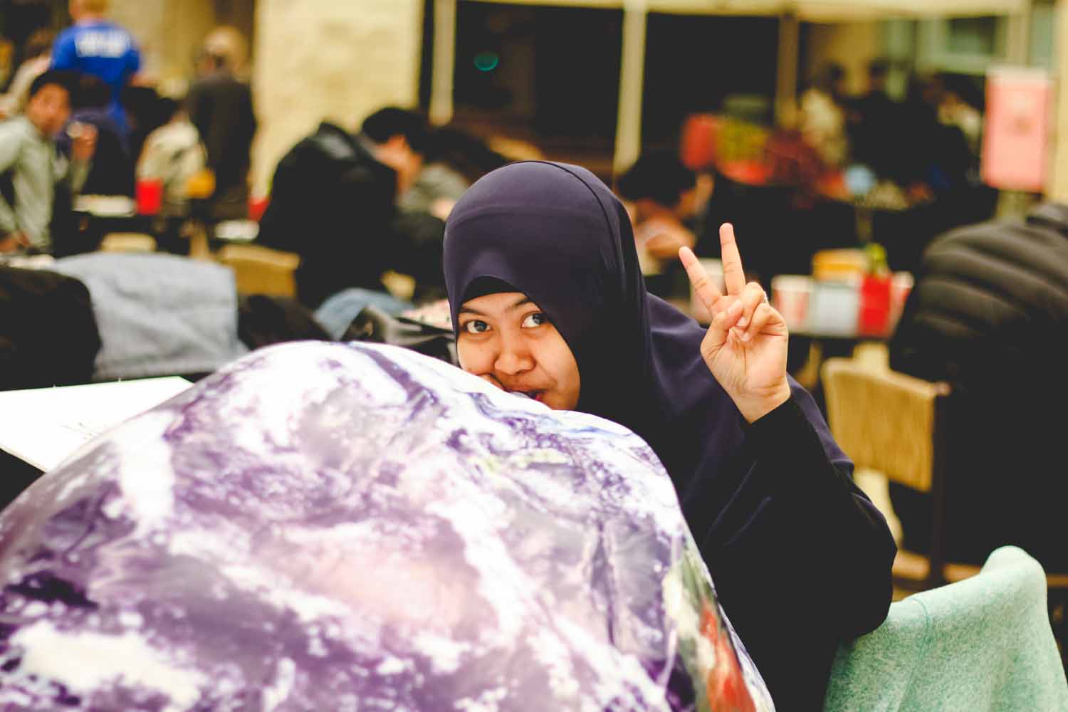 Dewi Endah Kharismawati, member of the Missouri International Student Council, aerates an Earth inflatable. Photo by Hanna Yowell.