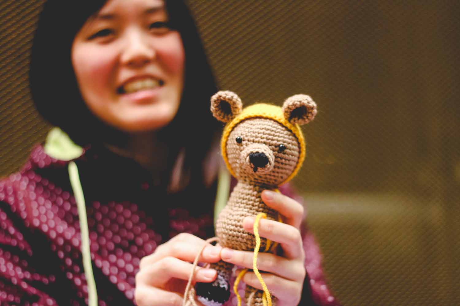 Nana Kizaki displays a handmade lion which she is in the process of crocheting. Photo by Hanna Yowell.