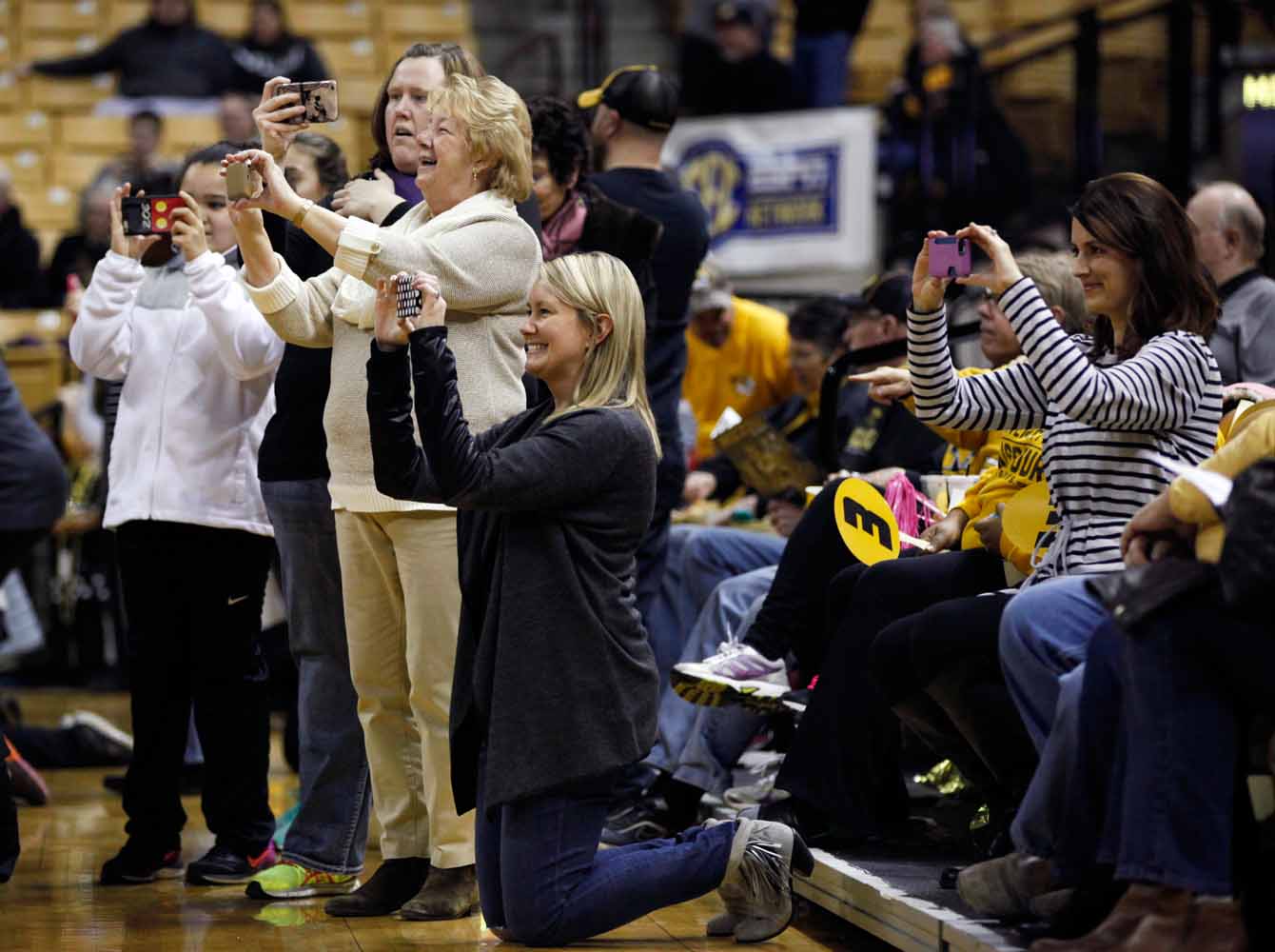 Parents record their daughters on their cell phones during a pre-game show with the Golden Girls Thursday evening, Feb. 11, 2016 at Mizzou Arena.