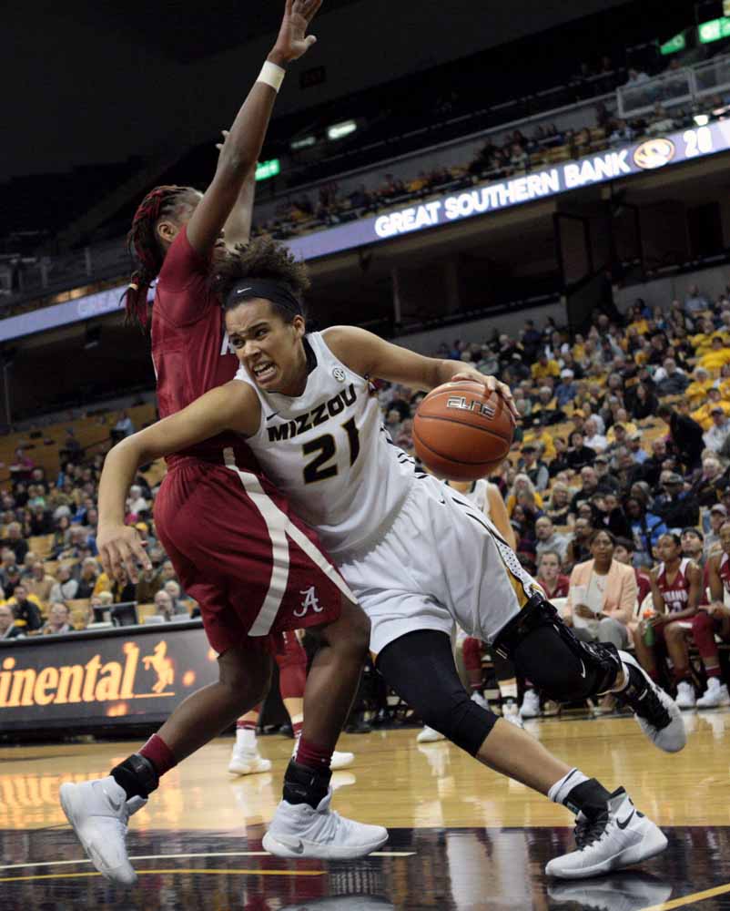 Mizzou's Cierra Porter (21) pushes past an Alabama player in hopes of scoring a couple points for the Tigers during the second quarter of the game Thursday evening, Feb. 11, 2016.